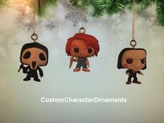 three funky pop vinyl figures hanging from a christmas tree with the words custom character ornaments on it