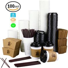 there are many cups and sticks on the table