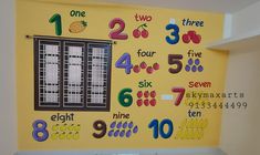 there is a wall with numbers on it in the children's playroom area