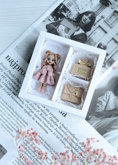 an open book with two small dolls in it