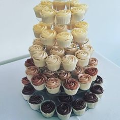 a tower of cupcakes with chocolate frosting on top