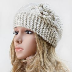 a mannequin head wearing a white knitted hat