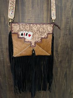 Moo-ve over, boring bags! Say hello to our Cowhide Handmade Tooled Leather Shoulder Crossbody Bag! Perfect for fashionistas and rugged queens alike. Great as a gift or a sneaky concealed carry purse. On sale now, so grab yours before it hoofs it out of here! Sling it, flaunt it, own it! 👜✨ Dimension:- Length: 28cm = 11" Height: 23cm = 9" Length with fringe: 46cm =18" PLEASE NOTE: The cowhide pattern varies from bag to bag as it's real cowhide and naturally the color markings vary. Western Style Crossbody Bags For Western-themed Events, Western Purses With Fringe, Cowhide Pattern, Western Crossbody Purse, Concealed Carry Bags, Myra Bags Cowhide Fringe, Cowhide Fringe Crossbody Bag, Western Bag, Concealed Carry Purse