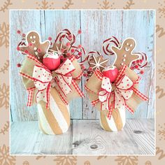 two gingerbread cookies in a jar decorated with red and white ribbon