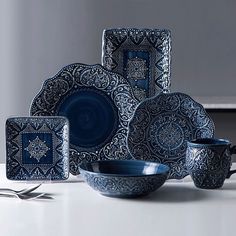 a blue and white dinnerware set on a table