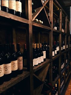 bottles of wine are lined up on shelves