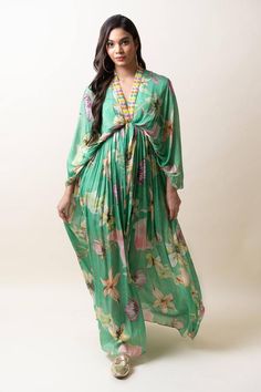 Green chiffon kaftan dress with floral print and sequins hand embroidered placket and neckline. Comes with an inner.
Components: 2
Pattern: Printed, Hand embroidered
Type Of Work: Floral, Sequins
Neckline: V Neck
Sleeve Type: Flared Sleeves
Fabric: Chiffon
Color: Green
Other Details: 
Length : Dress - 57 inches
Occasion: Party - Aza Fashions Festive Printed Dresses With Kimono Sleeves, Vacation Georgette Maxi Dress, Festive Printed Dress With Kimono Sleeves, Spring Printed Georgette Dresses, Festive Bohemian Georgette Maxi Dress, Floor-length Spring Festive Kaftan, Bohemian Georgette Evening Dress, Festive Floral Print Kaftan For Party, Green Silk Chiffon Dress For Spring