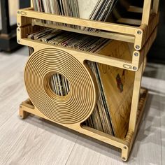 a wooden record rack with records on it