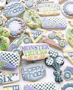 decorated cookies are arranged on a table for a birthday party with words and symbols in the middle