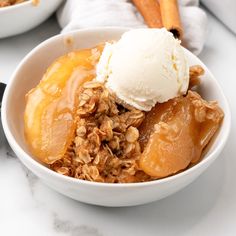 a bowl filled with granola and ice cream on top of a marble countertop