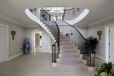 a staircase leading up to the second floor in a house with white walls and floors