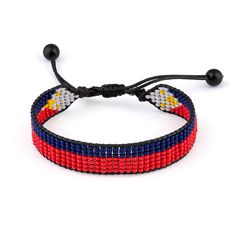 This Philippines Flag Beaded Bracelet is a stylish and patriotic accessory that celebrates the vibrant colors and rich heritage of the Philippines. Crafted with care, this adjustable bracelet features a bohemian-inspired rope design adorned with intricately woven beads in the iconic red, blue, and yellow hues of the Philippine flag. The adjustable nature of the bracelet ensures a comfortable and secure fit for both women and men, making it a versatile addition to any outfit. Whether youre a prou Patriotic Colorful Beads Bracelet For Gift, Patriotic Multicolor Friendship Jewelry, Patriotic Red Beaded Bracelets, Patriotic Red Adjustable Beaded Bracelet, Patriotic Multicolor Friendship Bracelets, Handmade Patriotic Multicolor Beaded Bracelets, Patriotic Multicolor Bracelet Jewelry, Philippines Flag, Flag Beads