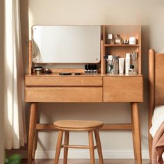 a wooden desk with a mirror and stool