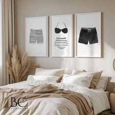 a bed with two pictures hanging above it and a wicker basket on the side