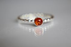 This uniquely speckled amber ring has a subtle, fall feel to it. I have set this 4mm round smooth genuine Baltic amber gemstone atop a beaded band. The 16 gauge solid sterling silver band has been also highly polished for a very reflective shine. This listing is for 1, 4mm amber gemstone ring. Material Information: Clarity: multi occlusions as with natural amber Color: light to dark Gemstone: amber Metal: .925 sterling silver Handcrafted band: 16 gauge (1.3mm) solid sterling wire Please contact Amber Gemstone, Natural Gemstone Ring, Amber Ring, Natural Amber, Black Gift Boxes, Amber Jewelry, Amber Color, Dream Jewelry, Sterling Silver Bands