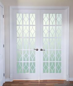 two white doors with frosted glass on them