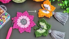 crocheted flowers and beads are arranged on a table