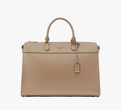 Looking for an elegant handbag that also fits your 16 laptop? We got you. This roomy Morgan style is done in scratch-resistant Saffiano leather with polished gold-tone hardware for a luxe look. | Kate Spade Morgan Laptop Bag, Timeless Taupe Gold Satchel With Detachable Strap For Work, Classic Gold Satchel For Workwear, Classic Gold Satchel For Office, Gold Rectangular Bags For Work, Rectangular Gold Bags For Work, Gold Rectangular Workwear Bags, Gold Satchel With Detachable Handle For Work, Gold Top Handle Satchel For Work, Elegant Laptop Bag For Business Trips