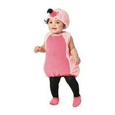 a baby in a pink dress and black leggings is wearing a pink costume