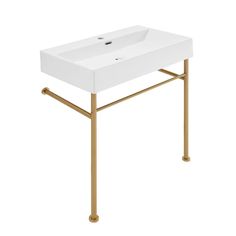 a white sink sitting on top of a metal stand with a gold frame around it