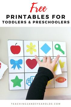 a child's hand is pointing at the printables for toddlers and preschoolers