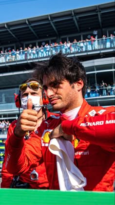 a man taking a selfie with his cell phone in front of a large crowd