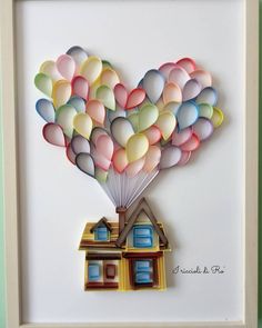 a house with balloons in the shape of a heart on it's roof is shown