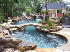 a backyard with a pool and waterfall