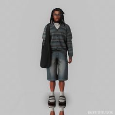 a man with dreadlocks is standing in front of a gray background wearing shorts and a sweater