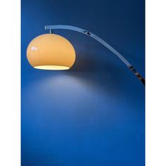 a lamp that is on the wall next to a blue background with a curved arm