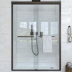 a bathroom with a glass shower door and towel rack on the wall next to it