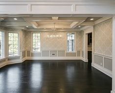 an empty room with wood flooring and white trim around the windows is seen in this image