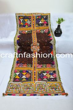 a table topped with a colorfully decorated cloth