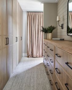 a bedroom with a large wooden dresser next to a window