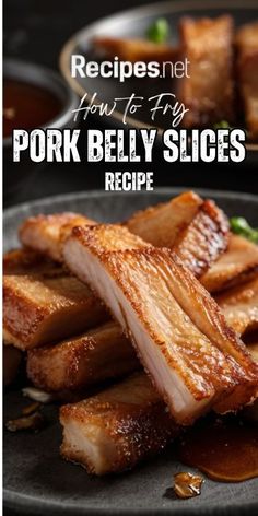 pork belly slices on a black plate with sauces and garnishes in the background