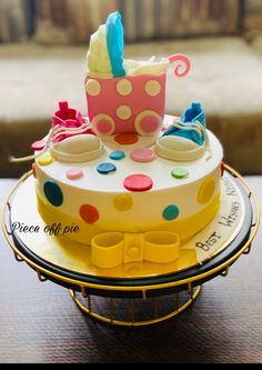 a cake that is on top of a plate with polka dots and a baby carriage