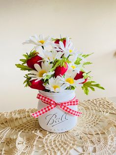 a vase filled with flowers on top of a doily