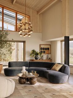 a living room filled with lots of furniture and large windows above it's walls