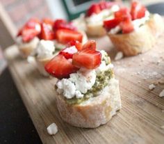 some food is sitting on a wooden board and ready to be eaten with someone in the background