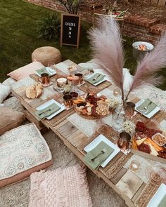 a table set up with plates, napkins and other items for an outdoor party