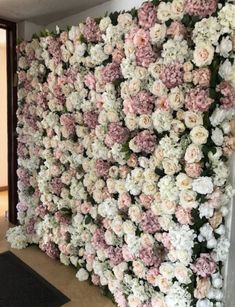 the wall is covered with pink and white flowers