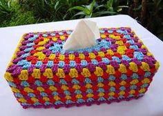 a colorful crocheted tissue box sitting on top of a table