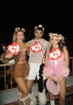 three people dressed in costumes posing for the camera