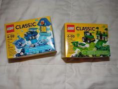 two legos sitting on top of a bed next to each other, one is blue and the other is green