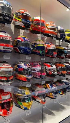 a display case filled with lots of different types of helmets on top of each other