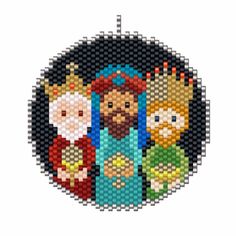 a cross stitch christmas ornament with three cartoon characters in the middle and one is wearing