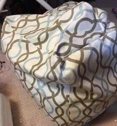 a white and blue bag sitting on top of a chair