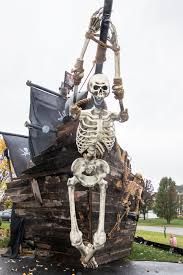 a skeleton sitting on top of a wooden structure