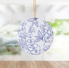 a ceramic ornament hanging from a wooden table