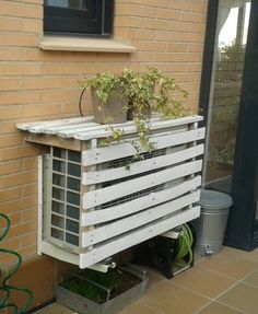 a window sill made out of pallets with a planter on the side